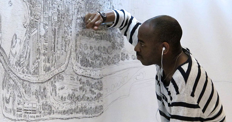 Stephen draws on a white wall