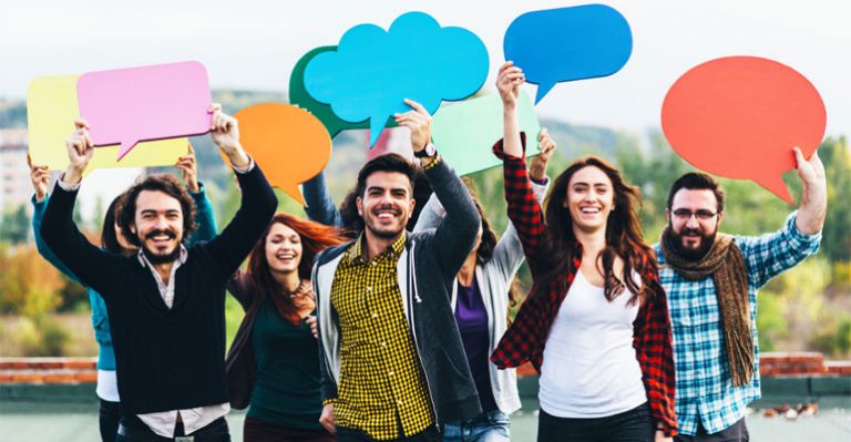 Group of people all holding colourful speech bubbles