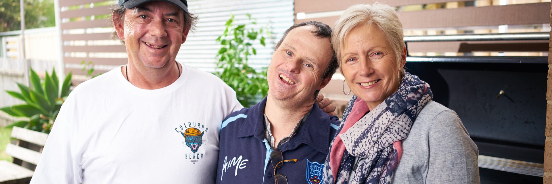 Two Aruma customers with a disability standing with their Disability Support Worker