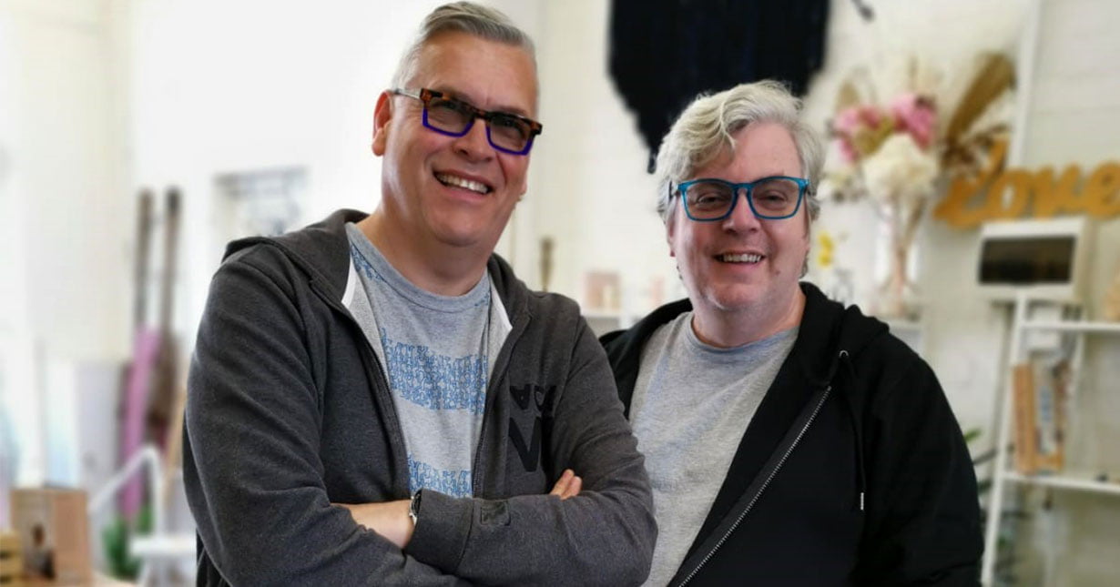 Derek and Stephen, wearing glasses and hoodies.