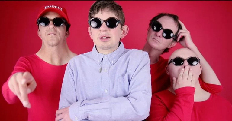 Members of Rudely interrupted in front of a red background