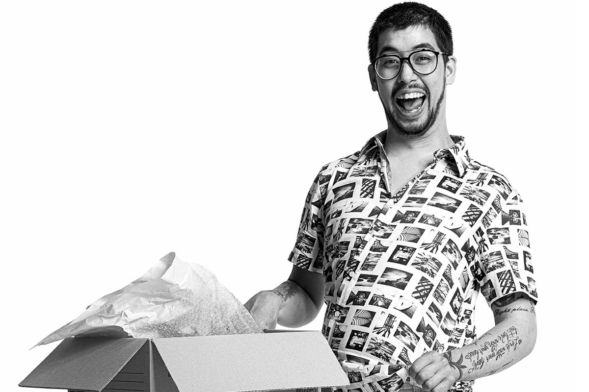 Man with a disability with a big smile holding a moving box